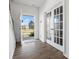 Bright entryway features wood flooring and adjacent glass paneled doors to flex space and open view to exterior at 1433 Harleston St, Indian Trail, NC 28079
