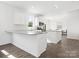 Contemporary kitchen featuring white cabinets, granite countertops, stainless steel appliances, and hardwood floors at 1433 Harleston St, Indian Trail, NC 28079