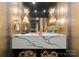 Modern powder room with a floating vanity and designer light fixtures at 1550 Queens W Rd, Charlotte, NC 28207