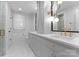 Sleek bathroom equipped with double sinks, stone countertops, contemporary lighting, and walk-in shower at 1550 Queens W Rd, Charlotte, NC 28207
