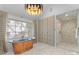 Bright bathroom with a standalone copper tub, a herringbone floor, and a glass-enclosed shower at 1550 Queens W Rd, Charlotte, NC 28207