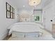Comfortable bedroom with neutral tones, decorative headboard, and a window nook perfect for relaxation at 1550 Queens W Rd, Charlotte, NC 28207