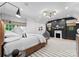 Stylish bedroom with a striking accent wall, unique light fixtures and a comfortable seating area at 1550 Queens W Rd, Charlotte, NC 28207