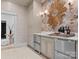 Butler pantry featuring a marble countertop, wine refrigerator, and decorative gold mirror, blending function and style at 1550 Queens W Rd, Charlotte, NC 28207
