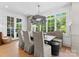Elegant dining area with large windows, stylish seating, and a unique chandelier at 1550 Queens W Rd, Charlotte, NC 28207