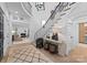Bright foyer with a curved staircase and an open view to the living room at 1550 Queens W Rd, Charlotte, NC 28207