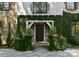Close up of the home's entry way with ivy, stone steps and an arched facade at 1550 Queens W Rd, Charlotte, NC 28207