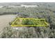 Aerial view outlining property borders, set amongst trees and distant neighboring homes at 1567 Jennings Rd, Statesville, NC 28625