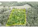 Aerial view highlighting the property lines of the home, nestled amidst a dense canopy of trees at 1567 Jennings Rd, Statesville, NC 28625