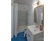 Bathroom featuring a shower with marbled tiling, a sink and blue carpeted floors at 1567 Jennings Rd, Statesville, NC 28625