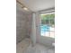 Bathroom with marble tile shower, and a large window overlooking the pool area at 1567 Jennings Rd, Statesville, NC 28625
