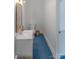 Neat half bathroom featuring a sink, toilet, and blue carpeted floors at 1567 Jennings Rd, Statesville, NC 28625