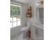Bright bathroom with a shower, toilet, vanity and a window overlooking the pool area at 1567 Jennings Rd, Statesville, NC 28625