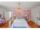 Charming bedroom with heart wallpaper accent, complemented by stylish decor and hardwood floors at 1567 Jennings Rd, Statesville, NC 28625