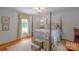 Bedroom featuring a four-poster bed, hardwood floors, and a window with decorative curtains at 1567 Jennings Rd, Statesville, NC 28625