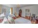 Bright, comfortable bedroom with two beds, an antique desk and an adjacent staircase at 1567 Jennings Rd, Statesville, NC 28625
