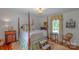 Bedroom with a four-poster bed, hardwood floors, bedside tables, and a window view at 1567 Jennings Rd, Statesville, NC 28625