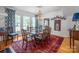 Elegant dining room featuring hardwood floors, stylish lighting, and ample seating, perfect for gatherings and entertaining at 1567 Jennings Rd, Statesville, NC 28625
