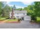 Exterior elevation showcasing the two-story home, lush lawn, and gravel driveway at 1567 Jennings Rd, Statesville, NC 28625