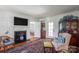 Cozy living room featuring a fireplace, hardwood floors, and stylish decor, creating a warm and inviting atmosphere at 1567 Jennings Rd, Statesville, NC 28625