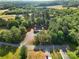 A home is surrounded by a lush forest in this aerial view at 1811 Continental Dr, Albemarle, NC 28001
