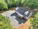 Home with a covered porch and expansive gravel driveway, aerial view at 1811 Continental Dr, Albemarle, NC 28001