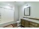 Bathroom features a tub with shower, toilet, sink, and a wooden vanity with drawers at 1811 Continental Dr, Albemarle, NC 28001