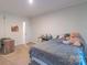 Neutral bedroom with a large teddy bear on the bed, and a door to another room at 1811 Continental Dr, Albemarle, NC 28001