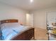 Bright bedroom with a wooden bed frame, a desk, and neutral walls at 1811 Continental Dr, Albemarle, NC 28001