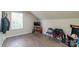 Bedroom featuring a sloped ceiling, window, and a Mortal Combat arcade game, adding a playful touch to the living space at 1811 Continental Dr, Albemarle, NC 28001