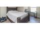 Bedroom with a dark bed frame, a desk, light laminate floors and neutral walls at 1811 Continental Dr, Albemarle, NC 28001