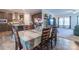 Open-concept dining area with wood floors, seamlessly connected to the modern kitchen with dark cabinets at 1811 Continental Dr, Albemarle, NC 28001