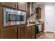 Modern kitchen with stainless appliances, granite countertops, and wooden cabinets at 1811 Continental Dr, Albemarle, NC 28001