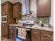 Modern kitchen with stainless appliances, granite countertops, and wooden cabinets at 1811 Continental Dr, Albemarle, NC 28001