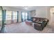 Inviting living room with large windows, plush carpet, and comfortable seating at 1811 Continental Dr, Albemarle, NC 28001