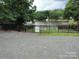 A fenced backyard looks out to the lake at 189 6Th Ave, New London, NC 28127