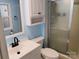 Bathroom featuring a white vanity, toilet, and shower with a glass door at 189 6Th Ave, New London, NC 28127