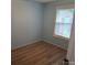 Bedroom with light blue walls and wood floors at 189 6Th Ave, New London, NC 28127