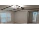 Bedroom with natural light from two windows, a modern light fixture, and a closet at 189 6Th Ave, New London, NC 28127