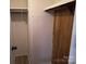 A storage closet with a wood-paneled wall offers convenient storage solutions at 189 6Th Ave, New London, NC 28127