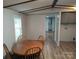 Inviting dining area featuring a wooden table and chairs, with an adjacent laundry area at 189 6Th Ave, New London, NC 28127