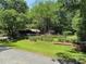 Charming home nestled amongst the trees with a storage shed and spacious fenced-in yard at 189 6Th Ave, New London, NC 28127