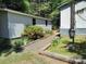 View of the home exterior with trees and landscaping surrounding the property at 189 6Th Ave, New London, NC 28127