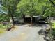 Cozy home with a carport, surrounded by mature trees on a spacious lot at 189 6Th Ave, New London, NC 28127