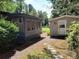 Home featuring a screened-in porch and a separate storage building at 189 6Th Ave, New London, NC 28127