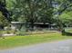 Well-maintained home with manicured lawn, mature trees, and enclosed yard space at 189 6Th Ave, New London, NC 28127