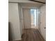Hallway with wood-look flooring, white doors, and access to a bathroom and closets at 189 6Th Ave, New London, NC 28127