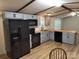 Modern kitchen featuring gray cabinetry, black appliances, and wood countertops at 189 6Th Ave, New London, NC 28127