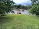 Enjoy the serene lake view from the grassy lawn at 189 6Th Ave, New London, NC 28127