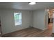An inviting living room boasts wood-look floors, natural light, and seamless flow to the kitchen at 189 6Th Ave, New London, NC 28127